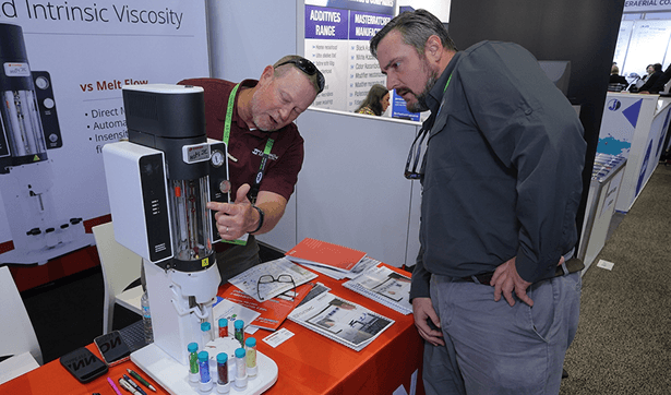 Industry professionals discussing materials at trade show